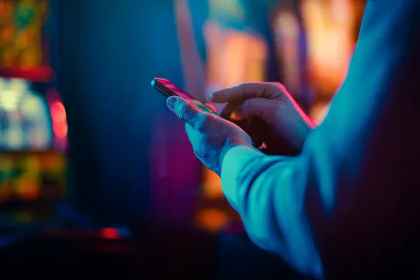 A woman in a luxurious green gown next to an ornate roulette wheel, capturing the upscale casino mood of JILI998.